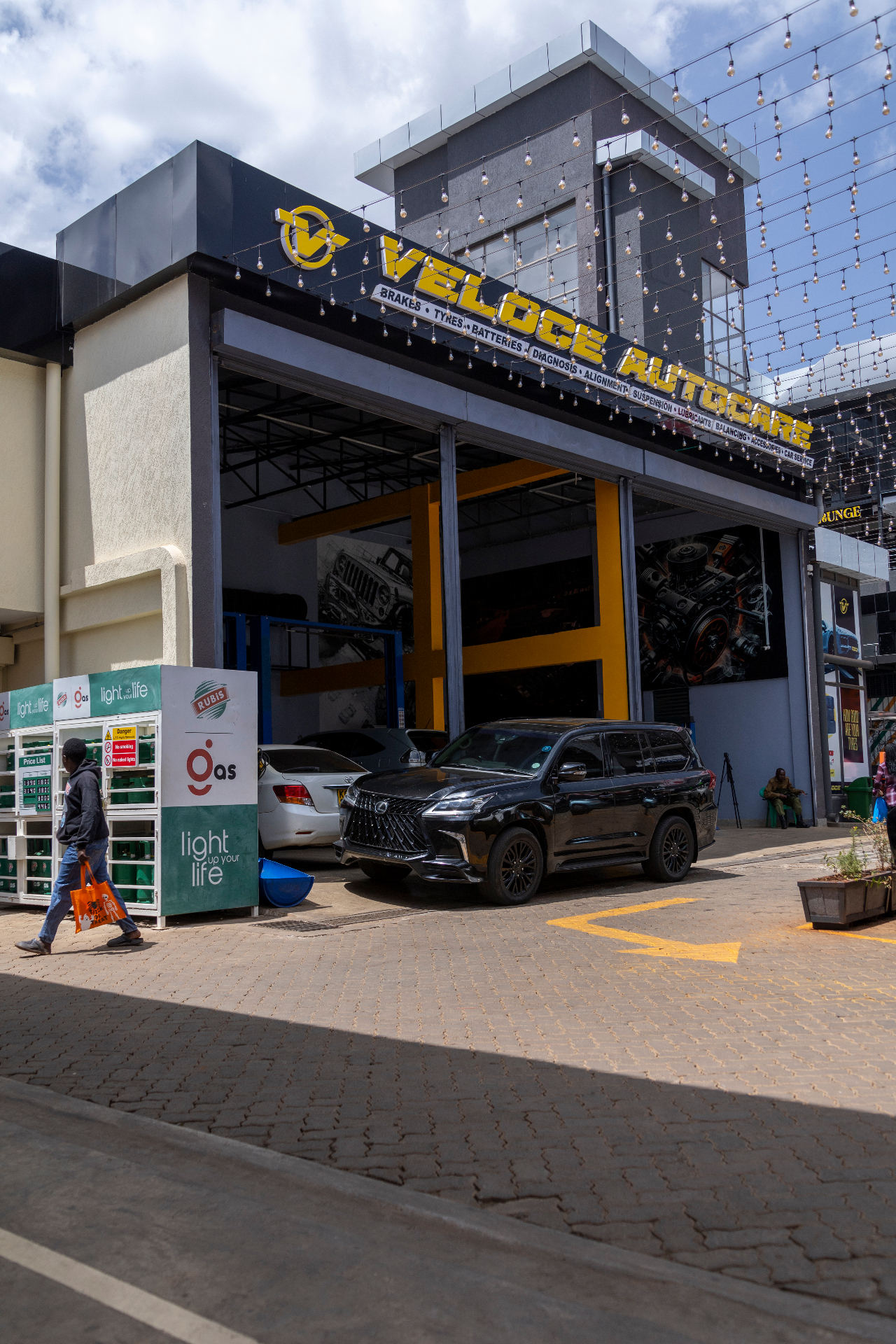 VELOCE entrance with luxury SUV